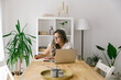 © STUDIO TAURUS - Mature woman taking notes from online webinar at home