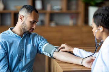 African american young man having regular checkup at practitioner