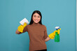 Delighted smiling and glad asian housemaid from daily routine holding spray and tissue, Cleaning home concept, Laughing cheerful and satisfied housekeeper with positive state of mind