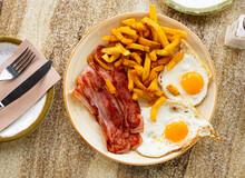 Delicious Breakfast - Scrambled Eggs With Bacon And French Fries