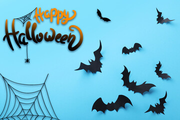 Wall Mural - Happy Halloween. Paper bats on light blue background, flat lay