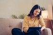 © Kritdanai - Confident pretty asian business woman working with laptop while doing some paperwork at home