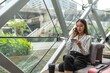© StockPhotoRepublic - Young beautiful asian female businesswoman lady calling the bank credit card center to ask for credit line increase to make a online payment purchase while in a random cafe