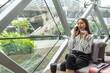 © StockPhotoRepublic - Young beautiful asian female businesswoman lady calling the bank credit card center to ask for credit line increase to make a online payment purchase while in a random cafe