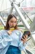 © StockPhotoRepublic - Young asian beautiful female lady making a payment for an online shopping purchase via her smart phone easily and successful while sitting in a cafe