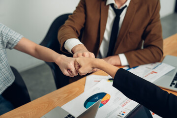 Wall Mural - Stack of hands symbolizing trust and cooperation, Group of professional business people are working and brainstorming discussed about work in conference room.