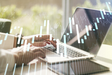 Double exposure of abstract creative financial diagram with hand typing on computer keyboard on background, banking and accounting concept