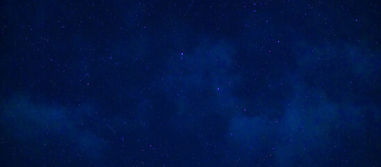 Wall Mural - Starry Milky Way at night with stars on the background of a dark blue night sky
