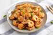 Homemade Crispy Salt and Pepper Shrimp with Scallions on a Plate, side view. Close-up.