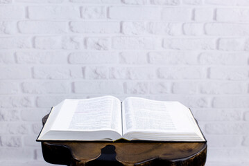 Wall Mural - Bible on the table. On the background of a brick wall. Open Holy Bible