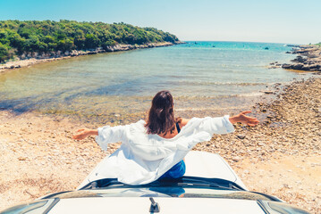 Poster - woman laying at car hood with view of sea summer beach