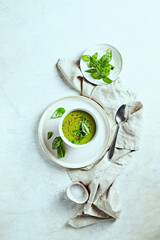 Wall Mural - Cream of green vegetable soup with herbs (seen from above). Healthy homemade food