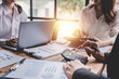 © Daenin - Young colleagues discussing business and price chart analyzes business people on the table great in modern coworking office teamwork concept. Calculate personal tax for customers