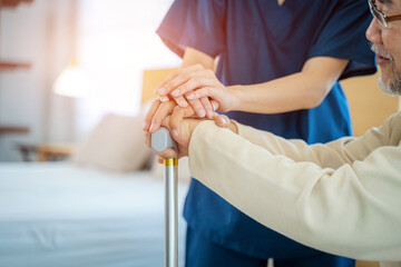 Caregiver hold hand of senior man patient give comfort,Express health care sympathy at nursing home,Concept senior people health care.