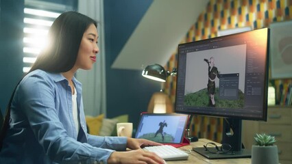 Wall Mural - asian female 3d designer making animation for video game character using modern computer and tablet 