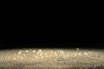 Wall Mural - shiny golden glitter on black background, space for text. bokeh effect