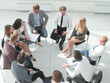 © ASDF - business training participants sitting in a circle and looking at the camera