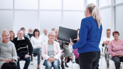 Businesswoman addressing colleagues at office meeting