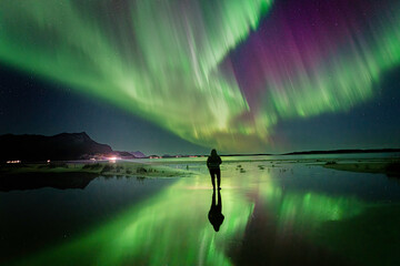 aurora's reflection and the woman on the beach
