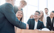 © ASDF - business partners shaking hands with each other during the meeting.
