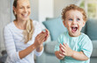 © Jade M/peopleimages.com - Happy, clapping hands and mother and son playing in the living room of their family home. Happiness, love and energy of parent and toddler having fun and cheering together in the lounge of a house.