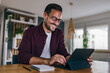 © bnenin - Smiling adult man working over the tablet, finishing the new company project.