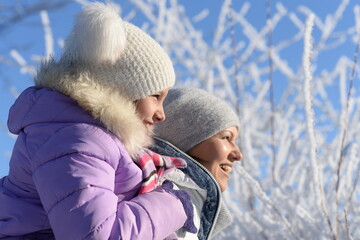 Wall Mural - Beautiful mother and daughter enjoy winter together