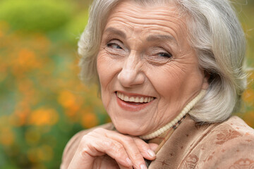 Poster - Senior woman walking in the park in autumn