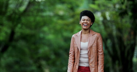 Wall Mural - Woman laughing outside. Happy African person real life laugh and smile