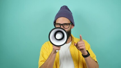 Wall Mural - Funny emotional guy with megaphone, talking proclaiming news, loudly announcing advertisement, hot news announce discounts sale hurry up communication concept. Studio video isolated on blue background