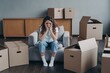 © VK Studio - Unhappy woman is sad because of relocation sitting near cardboard boxes. Hard moving day, divorce