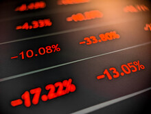Stock market price list with negative red numbers displayed on a pixelated monitor with dark background