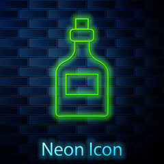 Sticker - Glowing neon line Alcohol drink Rum bottle icon isolated on brick wall background. Vector