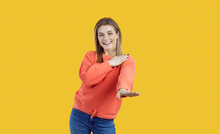 Happy Dancing Girl. Studio Shot Of Joyful Camp Counselor Or College Student. Good Looking Young Woman Smiling At Camera And Dancing Macarena To Cheerful Music Standing Isolated On Colour Background