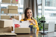 © Yingyaipumi - Young asian female selling clothes online by mobile phone live streaming.business women begin with small SME with online sales was happy with the ordered and on table are a lots of boxes ready to ship