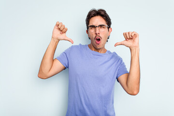 Wall Mural - Young hispanic man isolated on blue background feels proud and self confident, example to follow.