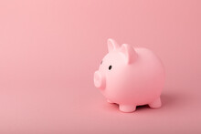 Piggy Bank On A Pink Background.The Concept Of Investment And Saving Money.Investments.Place For Milking Text. Place To Copy. Mockup