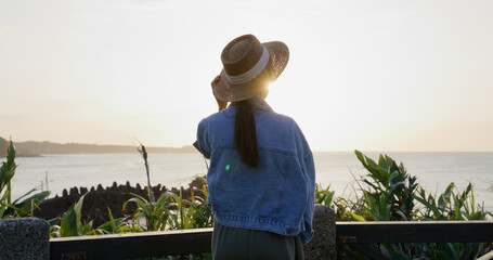 Poster - Woman look at the sunset sea view