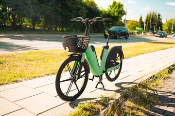 Modern green electric bike battery on a cycle in the street for rent