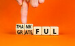 Thankful and grateful symbol. Concept words Thankful and Grateful on wooden cubes. Businessman hand. Beautiful orange table orange background. Business thankful and grateful concept. Copy space.