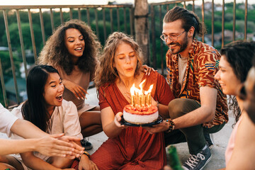 Wall Mural - A girl celebrates her birthday with friends at the rooftop party.