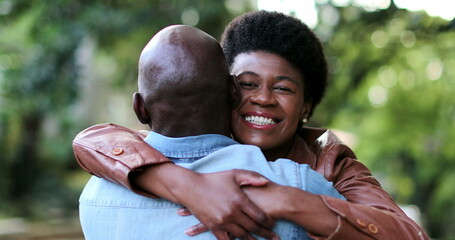 Wall Mural - Black woman running and hugging man. African couple embrace and hug