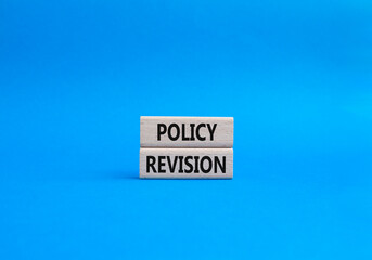 Sticker - Policy revision symbol. Concept word Policy revision on wooden blocks. Beautiful blue background. Business and Policy revision concept. Copy space