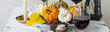 Idea for a beautiful autumn setting for thanksgiving family dinner or wedding. Orange pumpkin as decor. Cozy fall home atmosphere. Banner copy space for text