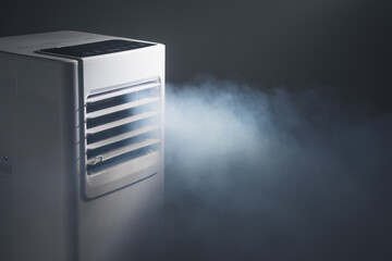 louvers outlet of portable air conditioner with cold steam, close-up view