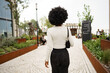 © fotofabrika - Back view of african woman walking in city