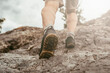 Person hiking in the mountains. Sport shoes outdoors close up