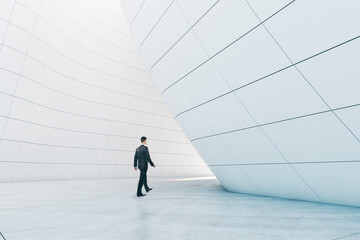 Poster - Man walking in abstract glass building open space interior.