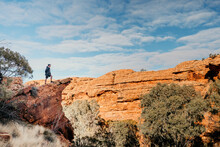 Man Stands Alone On Rocky Cliff