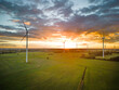 Aerial View of Windturbine against sunset with moody golden lighting